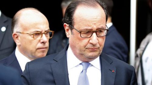French President Francois Hollande (R) and Interior Minister Bernard Cazeneuve (L) leave the city hall after two assailants had taken five people hostage in the church at Saint-Etienne-du -Rouvray near Rouen in Normandy, France, July 26, 2016. Two attackers killed a priest with a blade and seriously wounded another hostage in a church in northern France on Tuesday before being shot dead by French police. REUTERS/Pascal Rossignol